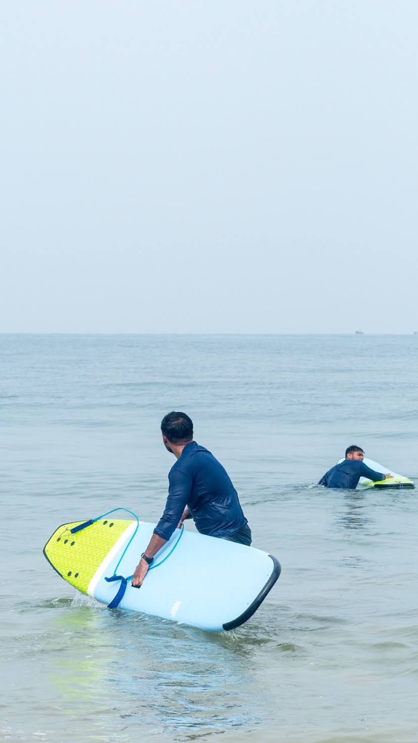 Heading out with a board at Weligama